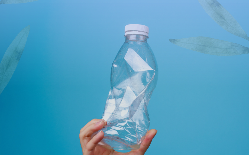 a hand holding a plastic water bottle 